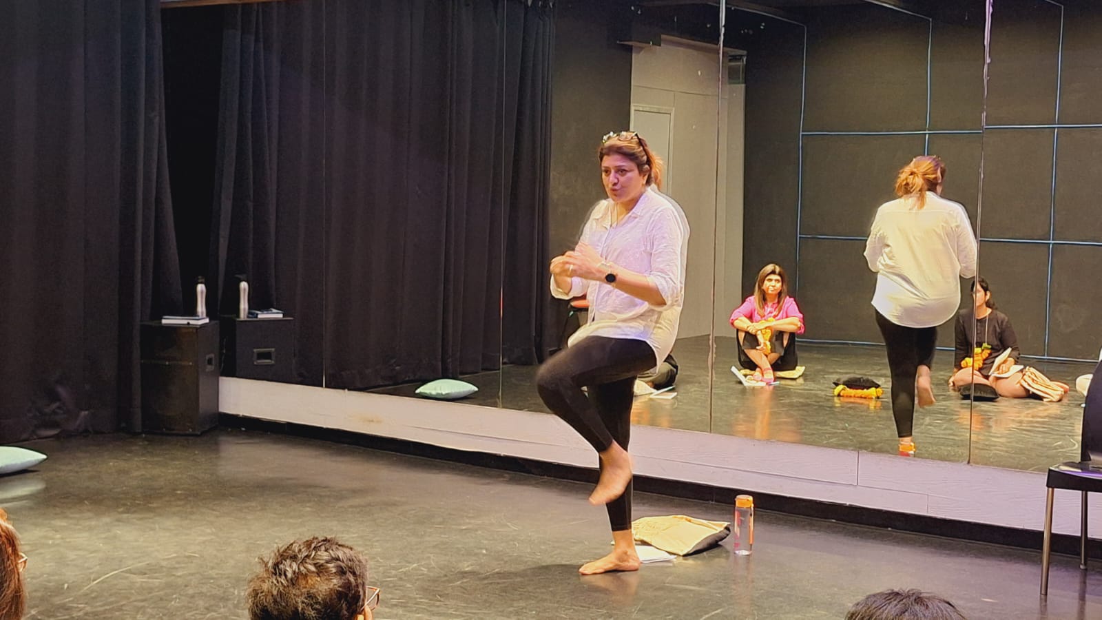 Meditation workshop with participants wearing flower garlands