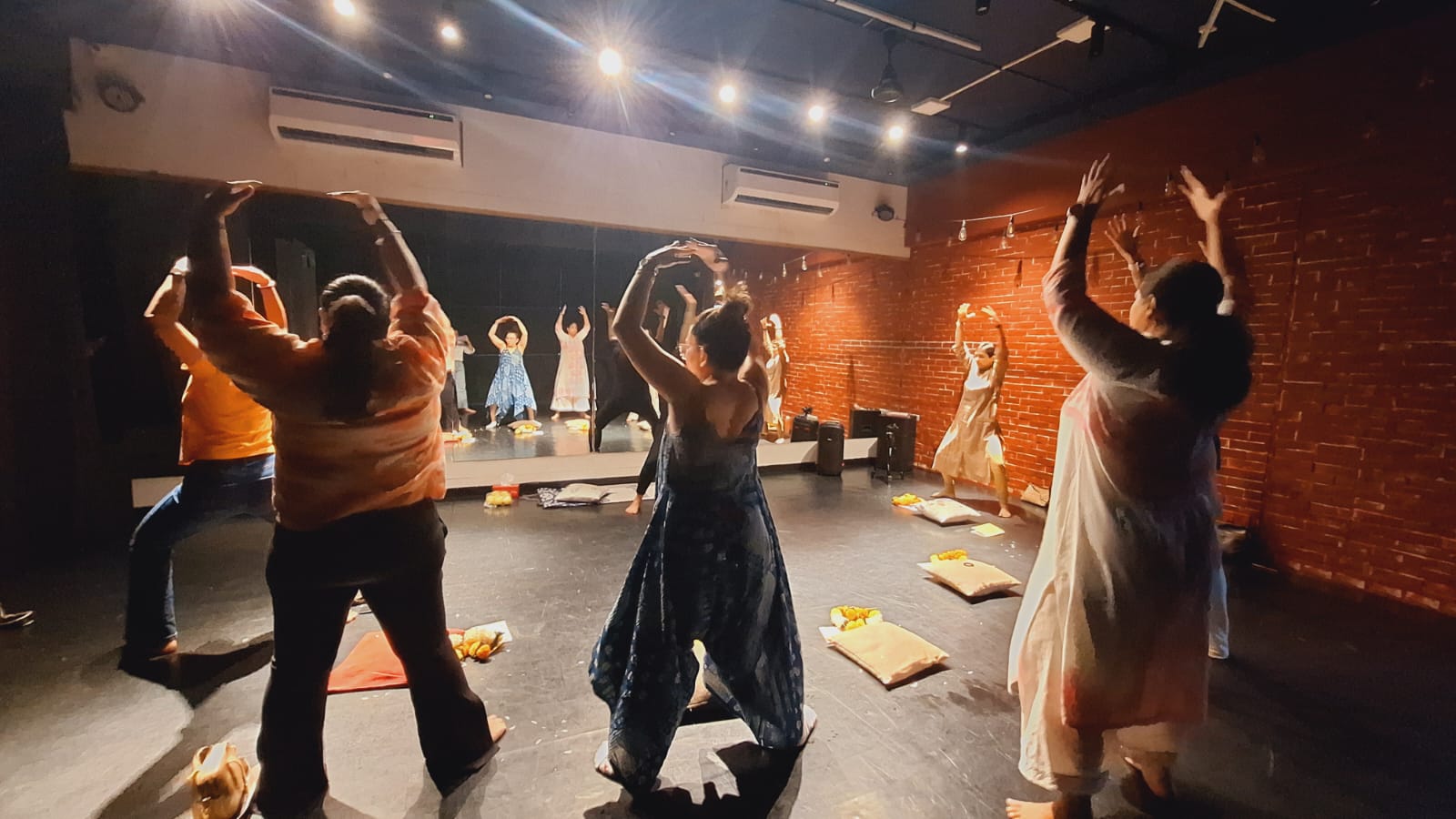 Meditation workshop with participants wearing flower garlands