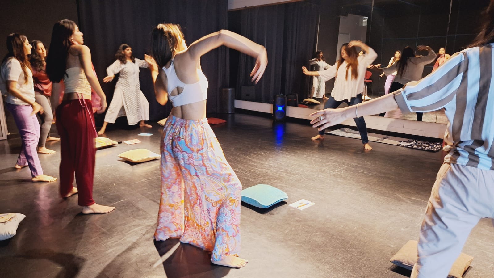 Meditation workshop with participants wearing flower garlands